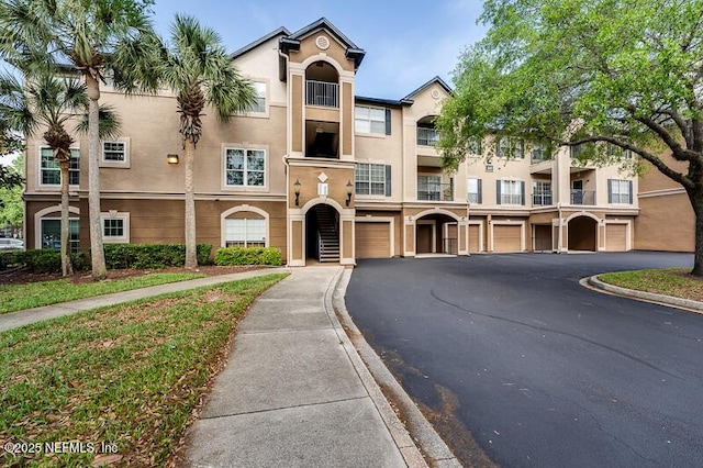 10961 Burnt Mill Rd Unit 321, Jacksonville, FL 32256 - exterior space with a garage, driveway, and stucco siding
