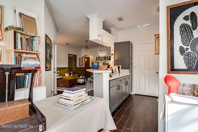 10961 Burnt Mill Rd Unit 321, Jacksonville, FL 32256 - kitchen with gray cabinetry, open floor plan, dark wood-style flooring, and light countertops