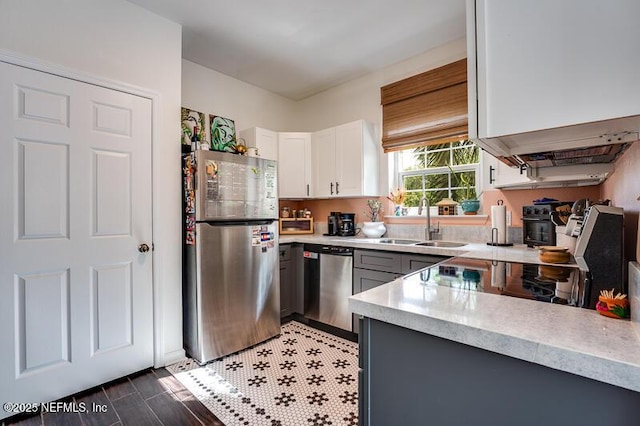 10961 Burnt Mill Rd Unit 321, Jacksonville, FL 32256 - kitchen featuring white cabinets, light countertops, a sink, and appliances with stainless steel finishes