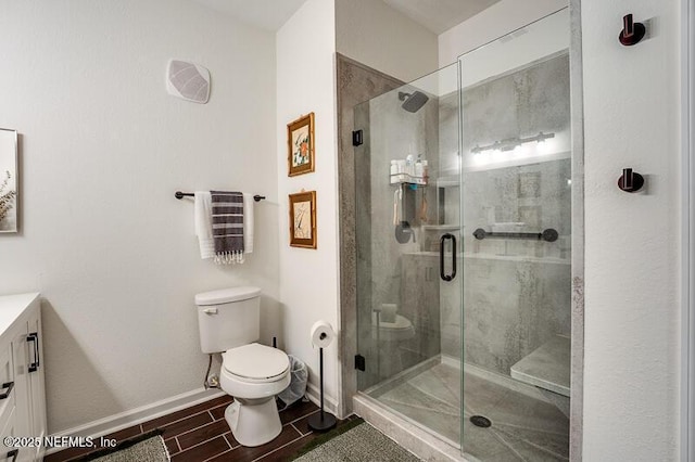 10961 Burnt Mill Rd Unit 321, Jacksonville, FL 32256 - bathroom featuring wood finish floors, vanity, toilet, a stall shower, and baseboards