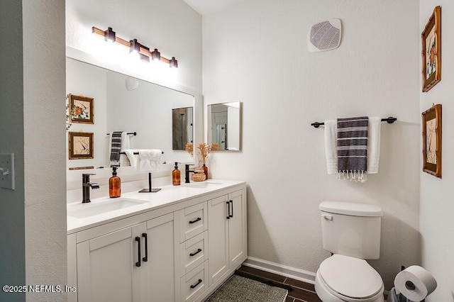 10961 Burnt Mill Rd Unit 321, Jacksonville, FL 32256 - full bathroom with toilet, double vanity, a sink, and baseboards