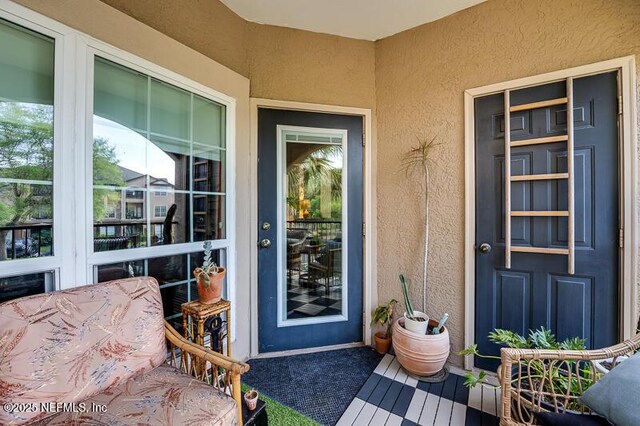 10961 Burnt Mill Rd Unit 321, Jacksonville, FL 32256 - view of exterior entry with stucco siding