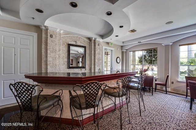 10961 Burnt Mill Rd Unit 321, Jacksonville, FL 32256 - bar featuring decorative columns, visible vents, and baseboards
