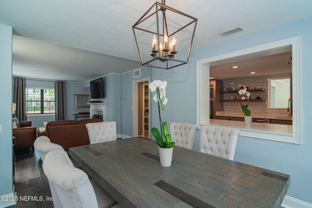 4245 Davinci Ave, Jacksonville, FL 32210 - dining room featuring visible vents, baseboards, an inviting chandelier, and wood finished floors