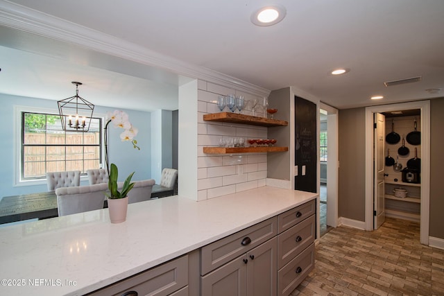 4245 Davinci Ave, Jacksonville, FL 32210 - bar featuring a chandelier, recessed lighting, pendant lighting, visible vents, and brick floor