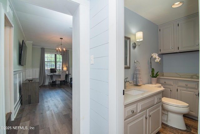 4245 Davinci Ave, Jacksonville, FL 32210 - bathroom featuring vanity, an inviting chandelier, recessed lighting, toilet, and hardwood / wood-style floors