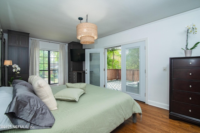 4245 Davinci Ave, Jacksonville, FL 32210 - bedroom with access to exterior, baseboards, and wood finished floors