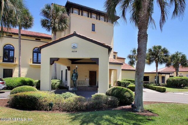 4245 Davinci Ave, Jacksonville, FL 32210 - mediterranean / spanish house with a tile roof and stucco siding