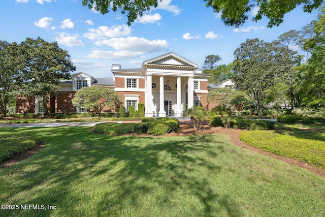 neoclassical home with a front yard