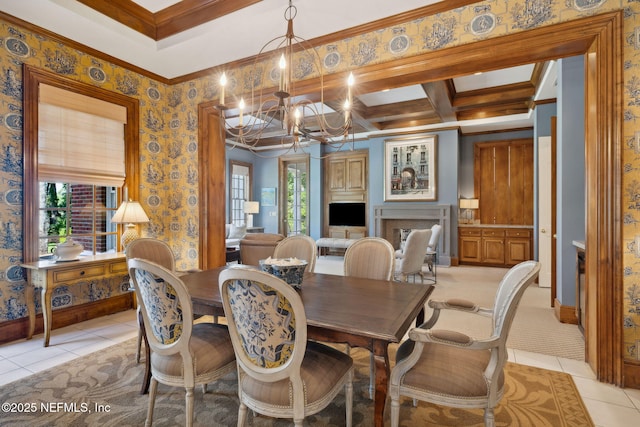 dining room with beam ceiling, light tile patterned floors, an inviting chandelier, ornamental molding, and wallpapered walls