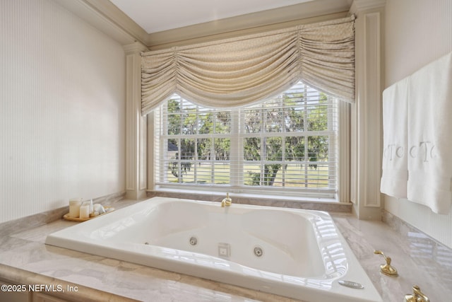 bathroom featuring a jetted tub, a wealth of natural light, and wallpapered walls