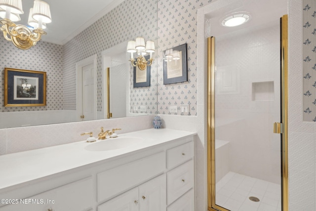 full bathroom featuring an inviting chandelier, ornamental molding, a stall shower, and wallpapered walls