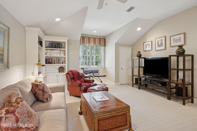living room with baseboards, vaulted ceiling, light colored carpet, and visible vents