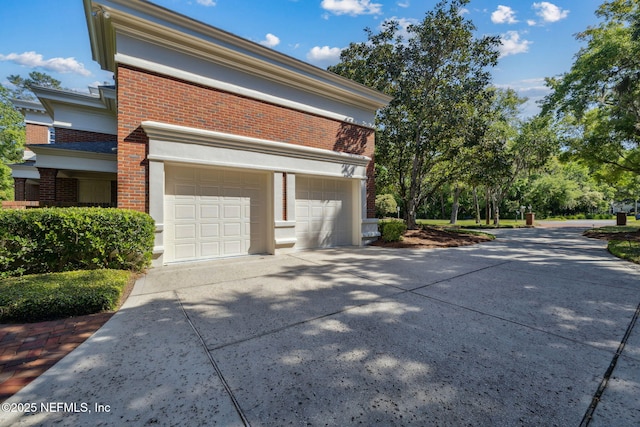 view of side of property featuring brick siding and driveway