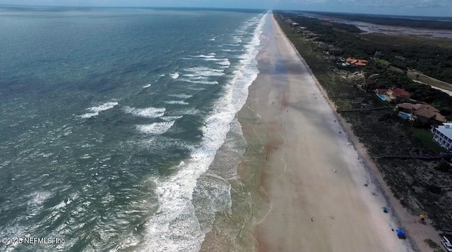 birds eye view of property featuring a water view and a view of the beach