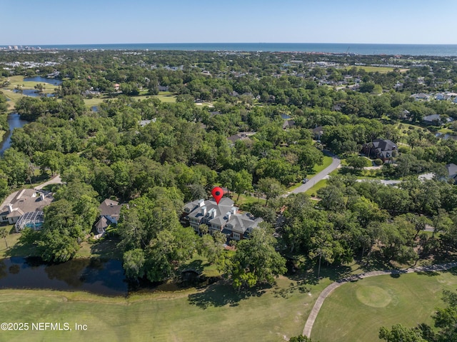 birds eye view of property with view of golf course and a water view