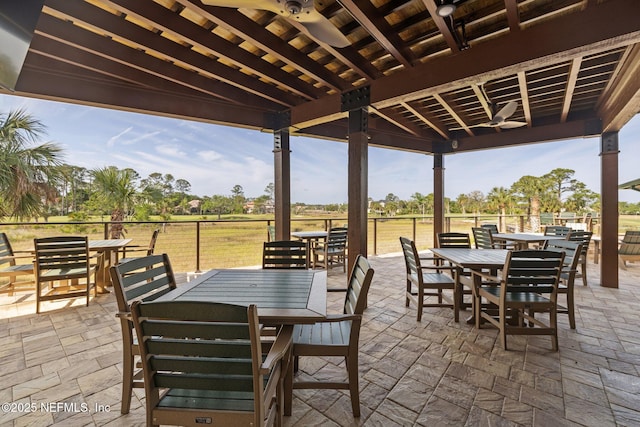 view of patio featuring ceiling fan and outdoor dining space
