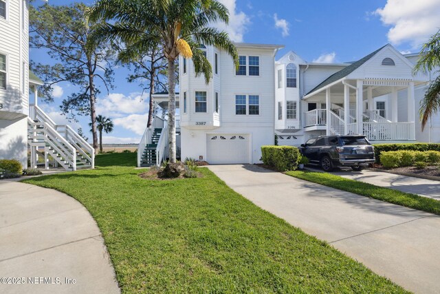 3387 Lighthouse Point Ln, Jacksonville, FL 32250 - view of front facade with a garage, stairway, driveway, and a front lawn