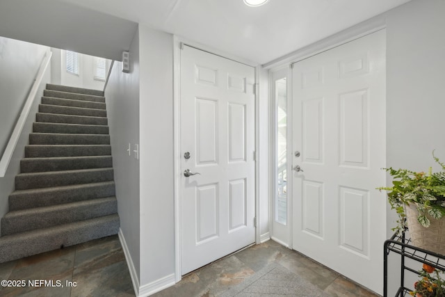 3387 Lighthouse Point Ln, Jacksonville, FL 32250 - entryway featuring baseboards, stone finish flooring, and stairs