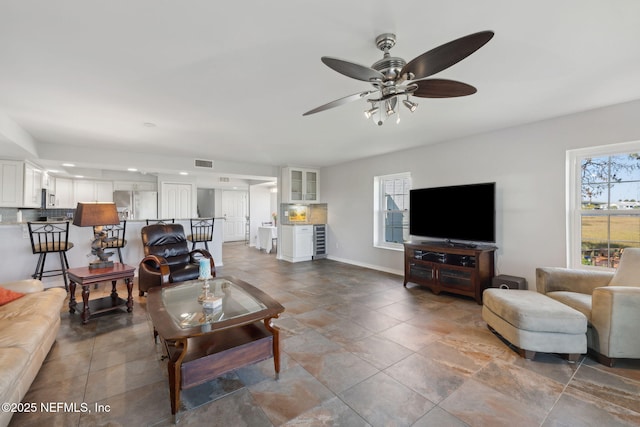 3387 Lighthouse Point Ln, Jacksonville, FL 32250 - living room featuring visible vents, ceiling fan, and baseboards