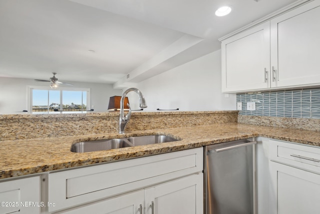 3387 Lighthouse Point Ln, Jacksonville, FL 32250 - kitchen featuring light stone counters, white cabinets, ceiling fan, dishwasher, and a sink