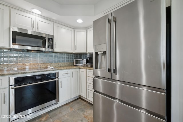 3387 Lighthouse Point Ln, Jacksonville, FL 32250 - kitchen with recessed lighting, a toaster, white cabinetry, backsplash, and stainless steel appliances