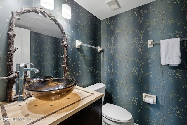 3387 Lighthouse Point Ln, Jacksonville, FL 32250 - half bath featuring vanity, wallpapered walls, and toilet