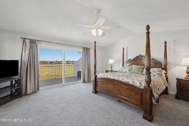 3387 Lighthouse Point Ln, Jacksonville, FL 32250 - bedroom with access to exterior, carpet flooring, vaulted ceiling, and a textured ceiling