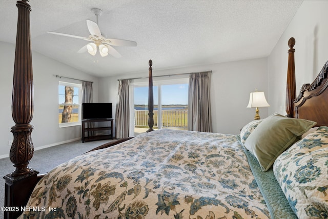 3387 Lighthouse Point Ln, Jacksonville, FL 32250 - carpeted bedroom with access to exterior, baseboards, vaulted ceiling, and a textured ceiling