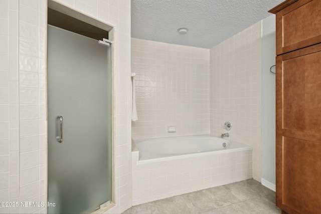 3387 Lighthouse Point Ln, Jacksonville, FL 32250 - full bathroom featuring tile patterned floors, a bath, a stall shower, and a textured ceiling