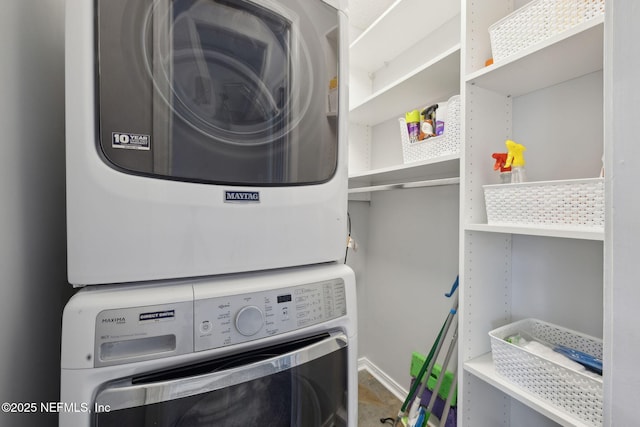 3387 Lighthouse Point Ln, Jacksonville, FL 32250 - washroom featuring stacked washing maching and dryer, laundry area, and baseboards