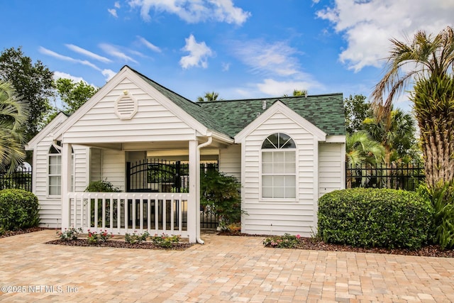 3387 Lighthouse Point Ln, Jacksonville, FL 32250 - exterior space with fence, a shingled roof, and covered porch