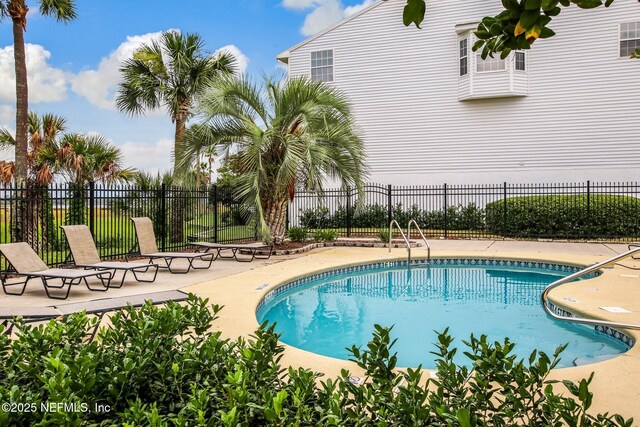 3387 Lighthouse Point Ln, Jacksonville, FL 32250 - community pool with a patio and fence
