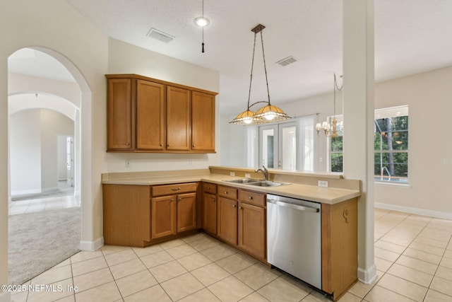 86183 Hampton Bays Dr, Fernandina Beach, FL 32034 - kitchen featuring dishwasher, brown cabinets, light countertops, and light tile patterned flooring