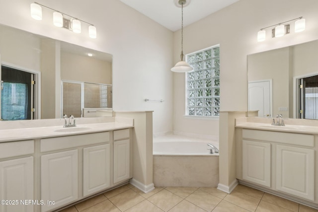 86183 Hampton Bays Dr, Fernandina Beach, FL 32034 - full bath featuring two vanities, a garden tub, a shower stall, and tile patterned floors