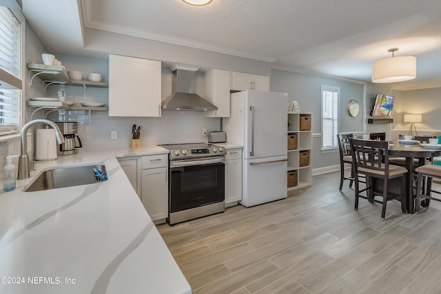 539 Upper 8th Ave S, Jacksonville Beach, FL 32250 - kitchen featuring open shelves, stainless steel electric range oven, a sink, freestanding refrigerator, and wall chimney exhaust hood