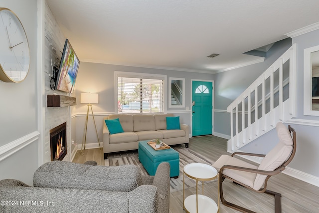 539 Upper 8th Ave S, Jacksonville Beach, FL 32250 - living room featuring crown molding, wood finished floors, a large fireplace, baseboards, and visible vents