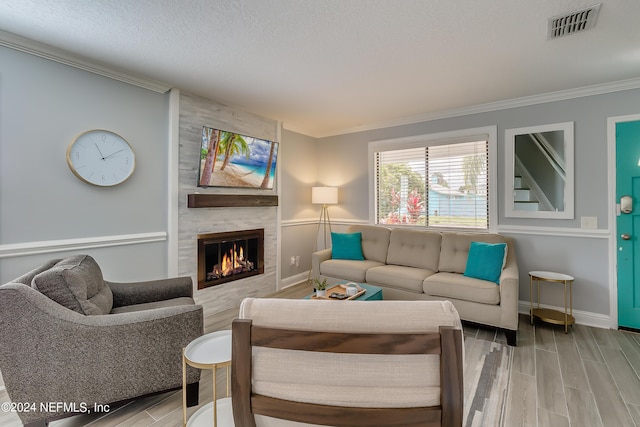 539 Upper 8th Ave S, Jacksonville Beach, FL 32250 - living room with wood tiled floor, visible vents, crown molding, and a tile fireplace