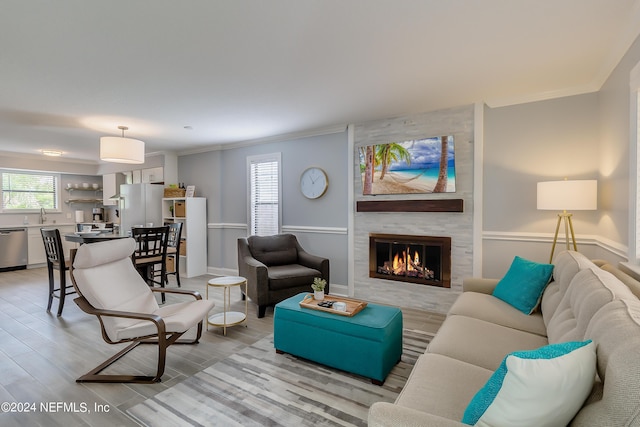 539 Upper 8th Ave S, Jacksonville Beach, FL 32250 - living area with light wood-type flooring, crown molding, and a large fireplace