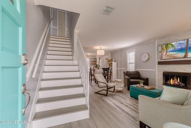 539 Upper 8th Ave S, Jacksonville Beach, FL 32250 - staircase with a fireplace, visible vents, and wood finished floors