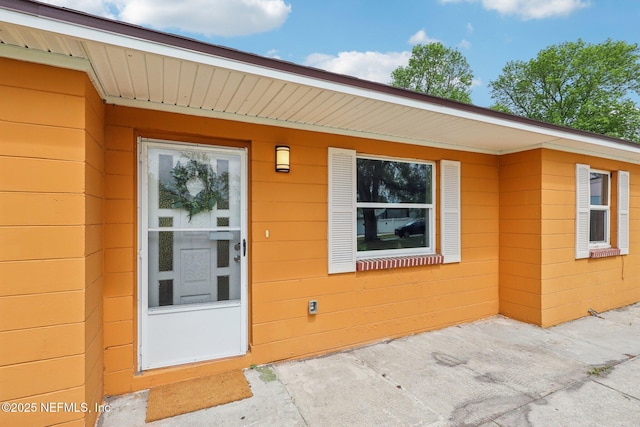 view of exterior entry with concrete block siding