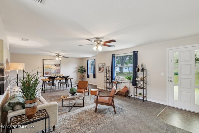 carpeted living area with baseboards, visible vents, and ceiling fan