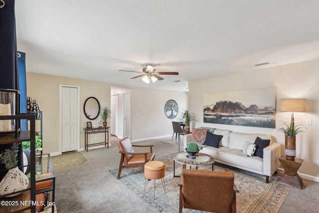 living room with baseboards, carpet flooring, visible vents, and a ceiling fan