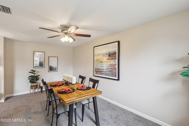 dining space with baseboards, carpet flooring, ceiling fan, and visible vents