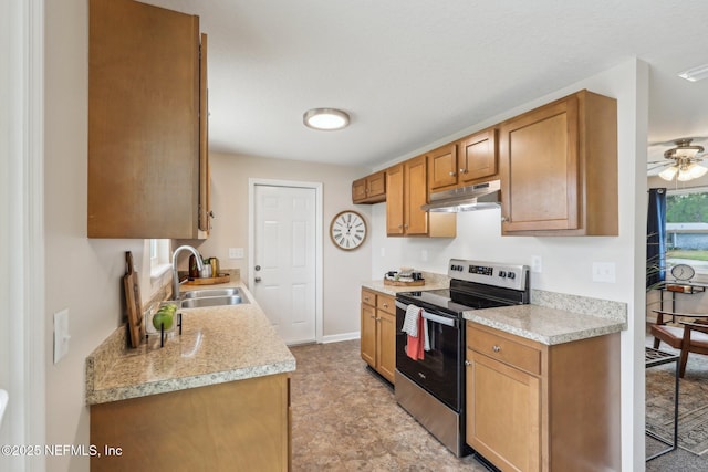 kitchen with light countertops, baseboards, stainless steel range with electric cooktop, under cabinet range hood, and a sink