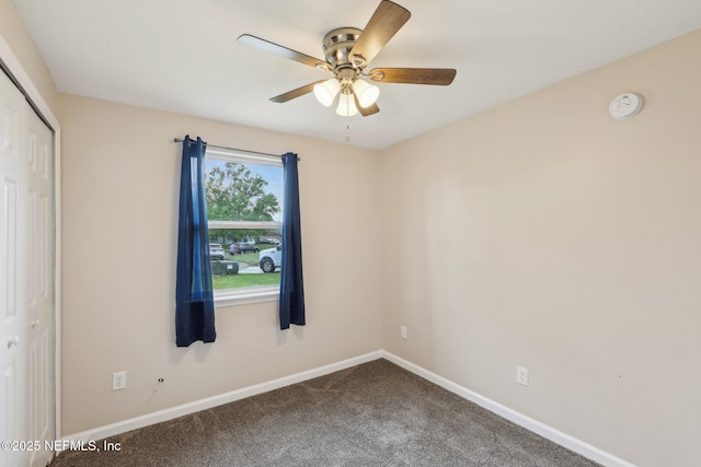 empty room with baseboards, carpet flooring, and a ceiling fan