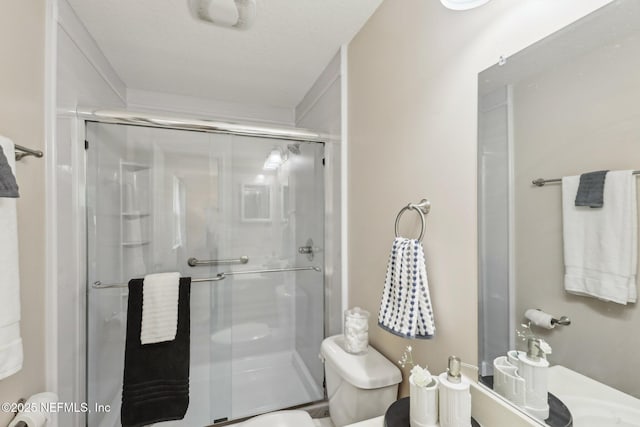 full bath featuring toilet and a stall shower