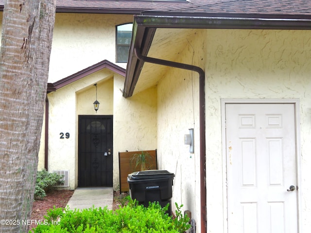 29 Fox Valley Dr, Orange Park, FL 32073 - view of exterior entry with a shingled roof and stucco siding