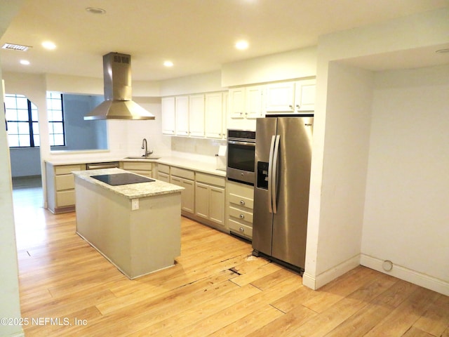 29 Fox Valley Dr, Orange Park, FL 32073 - kitchen with visible vents, light wood-style flooring, island exhaust hood, appliances with stainless steel finishes, and a sink
