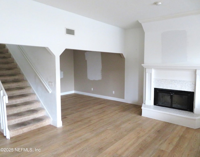 29 Fox Valley Dr, Orange Park, FL 32073 - unfurnished living room featuring visible vents, a high end fireplace, baseboards, stairs, and wood finished floors